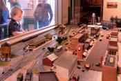 Child with model trains inside historic Mineola Depot